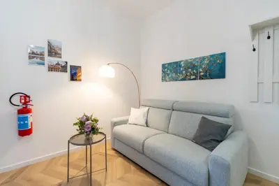 a living room with a couch and a table at BMGA l Poppy's Home Attic Vaticano in Rome
