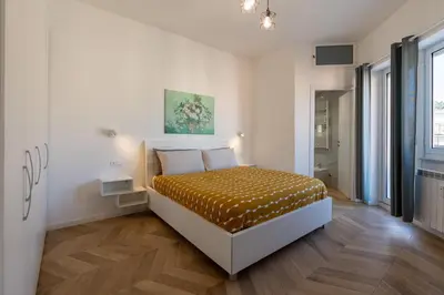 a bedroom with a bed in a room at BMGA l Poppy's Home Attic Vaticano in Rome