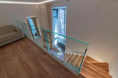 a glass staircase in a room with a couch at Heart of Rome - Pantheon View in Rome