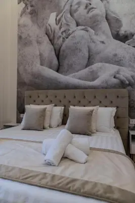 a bedroom with two beds with a painting on the wall at Heart of Rome - Pantheon View in Rome