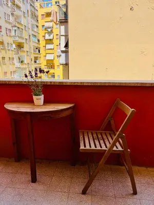 a table and a chair with a potted plant on it at Trastevere vibes in Rome