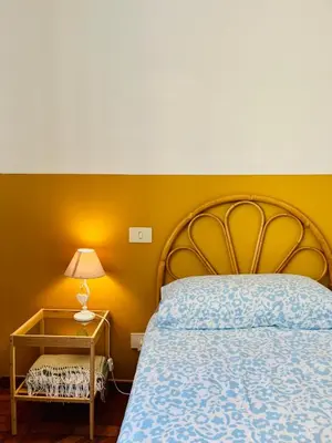 a bedroom with a bed and a table with a lamp at Trastevere vibes in Rome