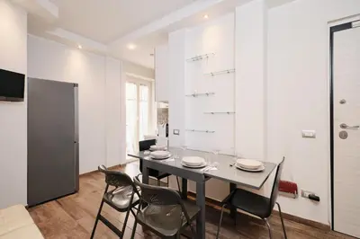 a dining room with a black table and chairs at A few minutes from the Colosseum - Free Wi-Fi & Netflix in Rome