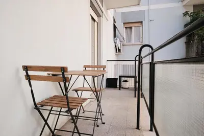 a small balcony with a table and chairs at A few minutes from the Colosseum - Free Wi-Fi & Netflix in Rome