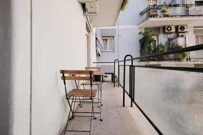 a balcony with a table and chairs on a building at A few minutes from the Colosseum - Free Wi-Fi & Netflix in Rome