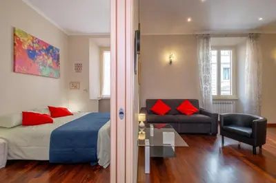 a bedroom with a bed and a couch and a table at Trevi Fountain big apartment in Rome