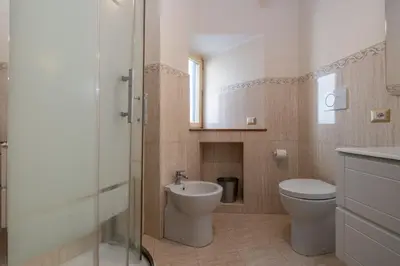 a bathroom with a toilet and a sink at Trevi Fountain big apartment in Rome
