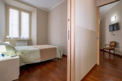 a bedroom with a bed and a sliding glass door at Trevi Fountain big apartment in Rome