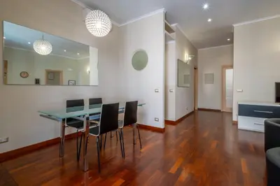 a dining room with a table and chairs at Trevi Fountain big apartment in Rome