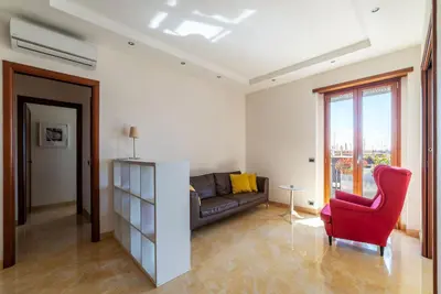 a living room with a couch and a red chair at GuestHost - Bright Apartment in Monteverde in Rome