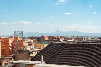 a city with buildings and a bird flying in the sky at GuestHost - Bright Apartment in Monteverde in Rome