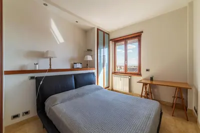 a bedroom with a bed and a desk and a window at GuestHost - Bright Apartment in Monteverde in Rome