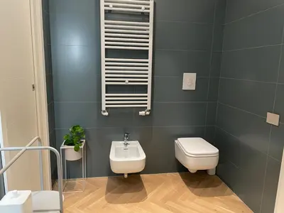 a bathroom with a toilet and a sink at GuestHost - Trastevere Modern Apartment in Rome