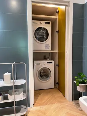 a laundry room with a washer and dryer at GuestHost - Trastevere Modern Apartment in Rome