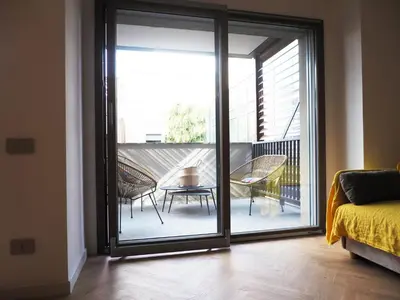 a room with a sliding glass door leading to a balcony at GuestHost - Trastevere Modern Apartment in Rome