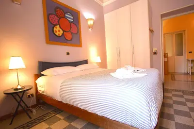 a bedroom with a large white bed in a room at Mameli Holiday House in Rome