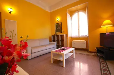 a living room with a couch and a table at Mameli Holiday House in Rome
