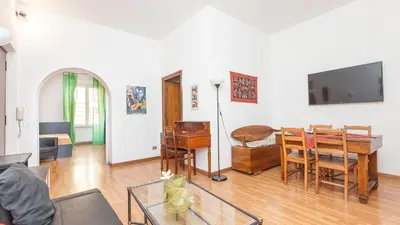 a living room with a table and a tv at Rental in Rome Santini apartment in Rome