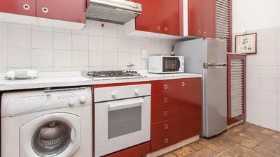 a kitchen with a washing machine and a refrigerator at Rental in Rome Santini apartment in Rome