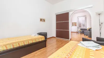 a bedroom with a bed and a living room at Rental in Rome Santini apartment in Rome