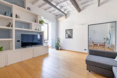a living room with a television and a couch at Boschetto Apt - Homkeey Apartments in Rome