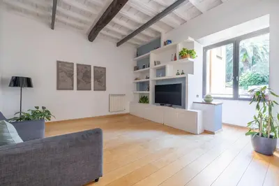 a living room with a tv and a couch at Boschetto Apt - Homkeey Apartments in Rome