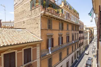 an apartment building with a balcony on a city street at Boschetto Apt - Homkeey Apartments in Rome