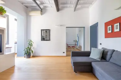 a living room with a couch and a tv at Boschetto Apt - Homkeey Apartments in Rome