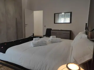 a bedroom with a large white bed with two pillows at Silvia Apartment in Rome