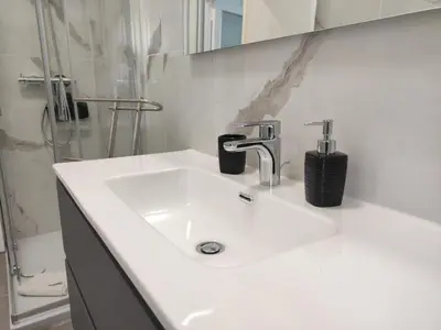 a white sink in a bathroom with a shower at Silvia Apartment in Rome