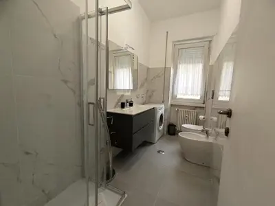 a bathroom with a shower and a sink and a tub at Silvia Apartment in Rome
