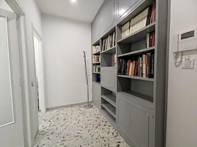 a room with a book shelf filled with books at Silvia Apartment in Rome