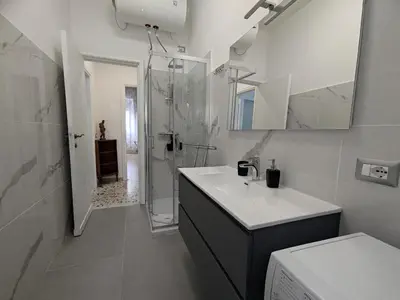 a bathroom with a sink and a shower and a toilet at Silvia Apartment in Rome