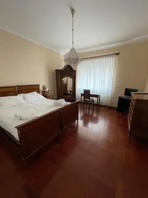 a bedroom with a large bed and a table at Vatican Vibes - 5 minutes from the Pope in Rome