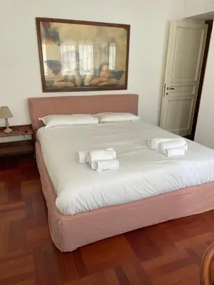 a bedroom with a large bed with towels on it at Vatican Vibes - 5 minutes from the Pope in Rome