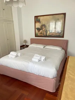 a bedroom with a bed with two towels on it at Vatican Vibes - 5 minutes from the Pope in Rome