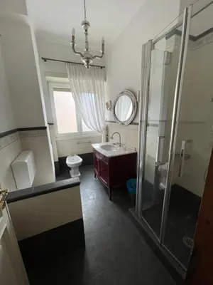 a bathroom with a sink and a shower and a mirror at Vatican Vibes - 5 minutes from the Pope in Rome