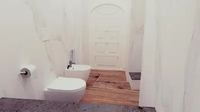 a white bathroom with a toilet and a door at Apartament Leutari in Rome