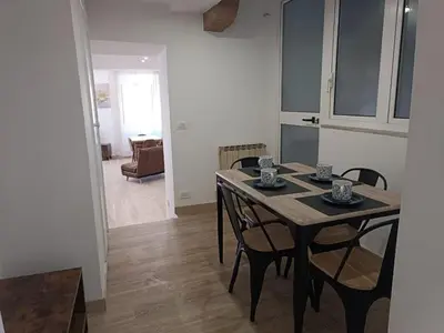a dining table and chairs in a living room at Ottavia apartment in Rome