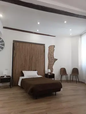 a bedroom with a large bed and two chairs at Ottavia apartment in Rome