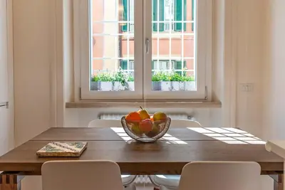 a wooden table with a bowl of fruit on it at Baglivi 8 - Sapienza - Metro B in Rome