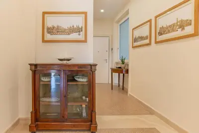 a hallway with a glass cabinet in a house at Baglivi 8 - Sapienza - Metro B in Rome