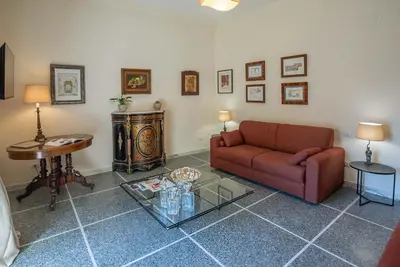 a living room with a couch and a table at Baglivi 8 - Sapienza - Metro B in Rome