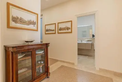 a room with a wooden cabinet and a bathroom at Baglivi 8 - Sapienza - Metro B in Rome