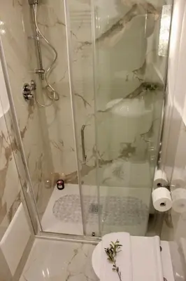 a bathroom with a shower with a glass door at Hideaway 65 - Home by St Peter's in Rome