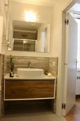 a bathroom with a sink and a mirror at Hideaway 65 - Home by St Peter's in Rome