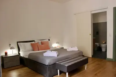 a bedroom with a bed with two towels on it at Hideaway 65 - Home by St Peter's in Rome