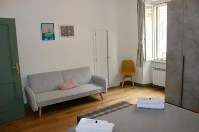 a living room with a couch and a table at Hideaway 65 - Home by St Peter's in Rome