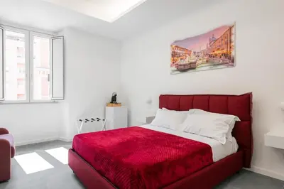 a bedroom with a red bed with a red blanket at 753 Roma in Rome