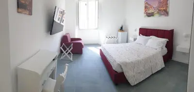 a bedroom with a bed and a chair at 753 Roma in Rome